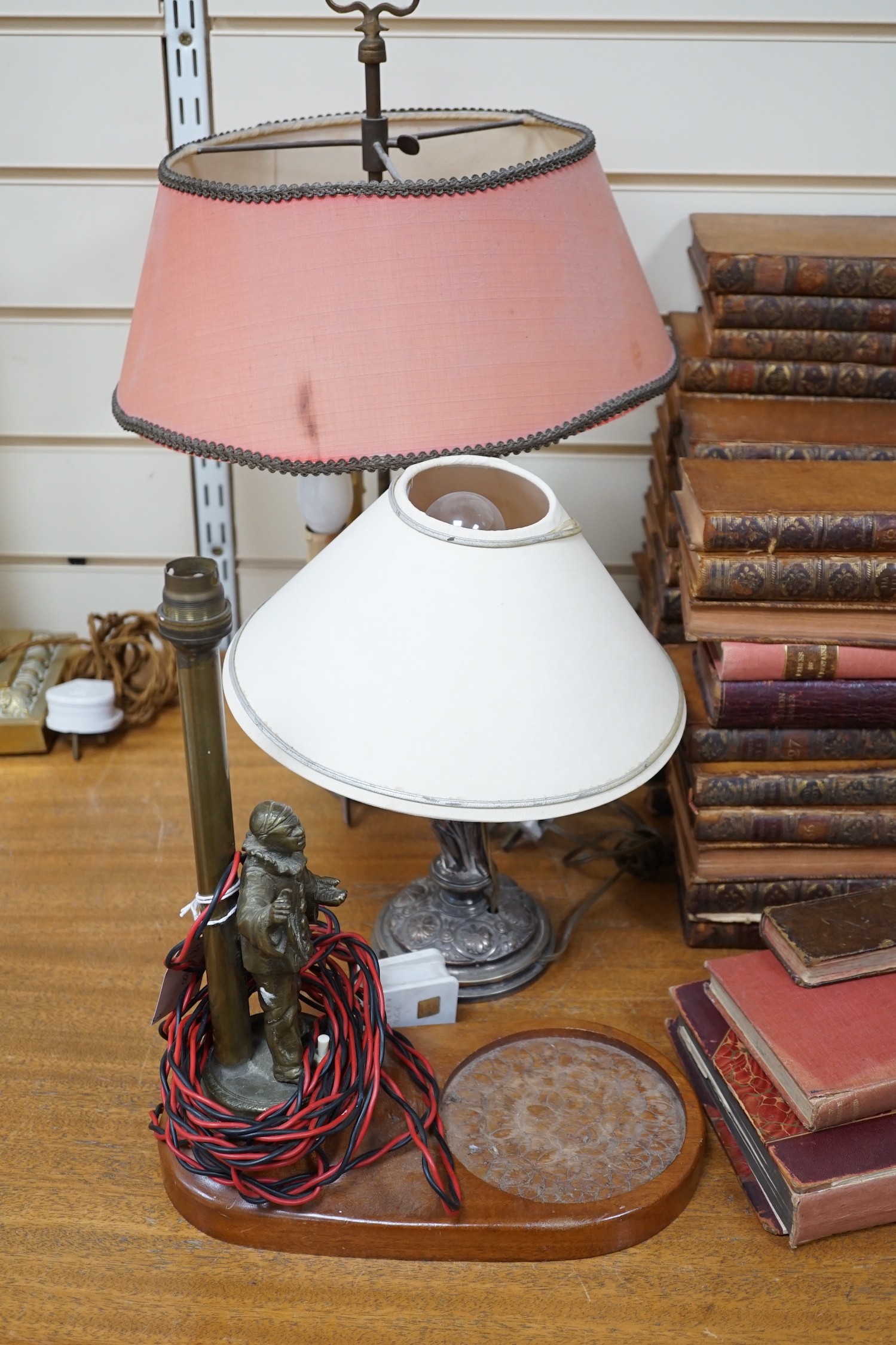 A Sheffield plated figural table lamp, A brass figural ‘Pierrot’ table lamp and An Eastern brass converted lamp with attached snuffer